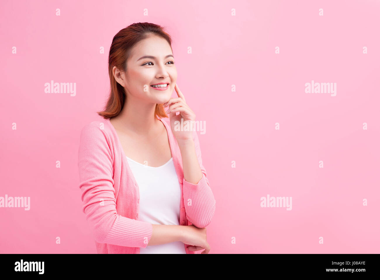 Beauty Asian Young Portrait. Beautiful Thinking Woman Touching her Face. Stock Photo
