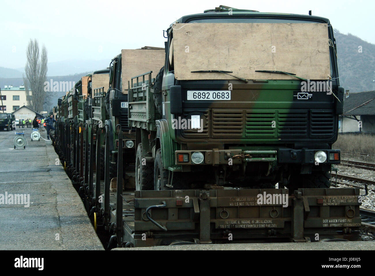 MITROVICA, KOSOVO - FEBRUARY 17, 2009: French army truck being shipped on a train, ready to leave the train station of Kosovska Mitrovica, as a part o Stock Photo