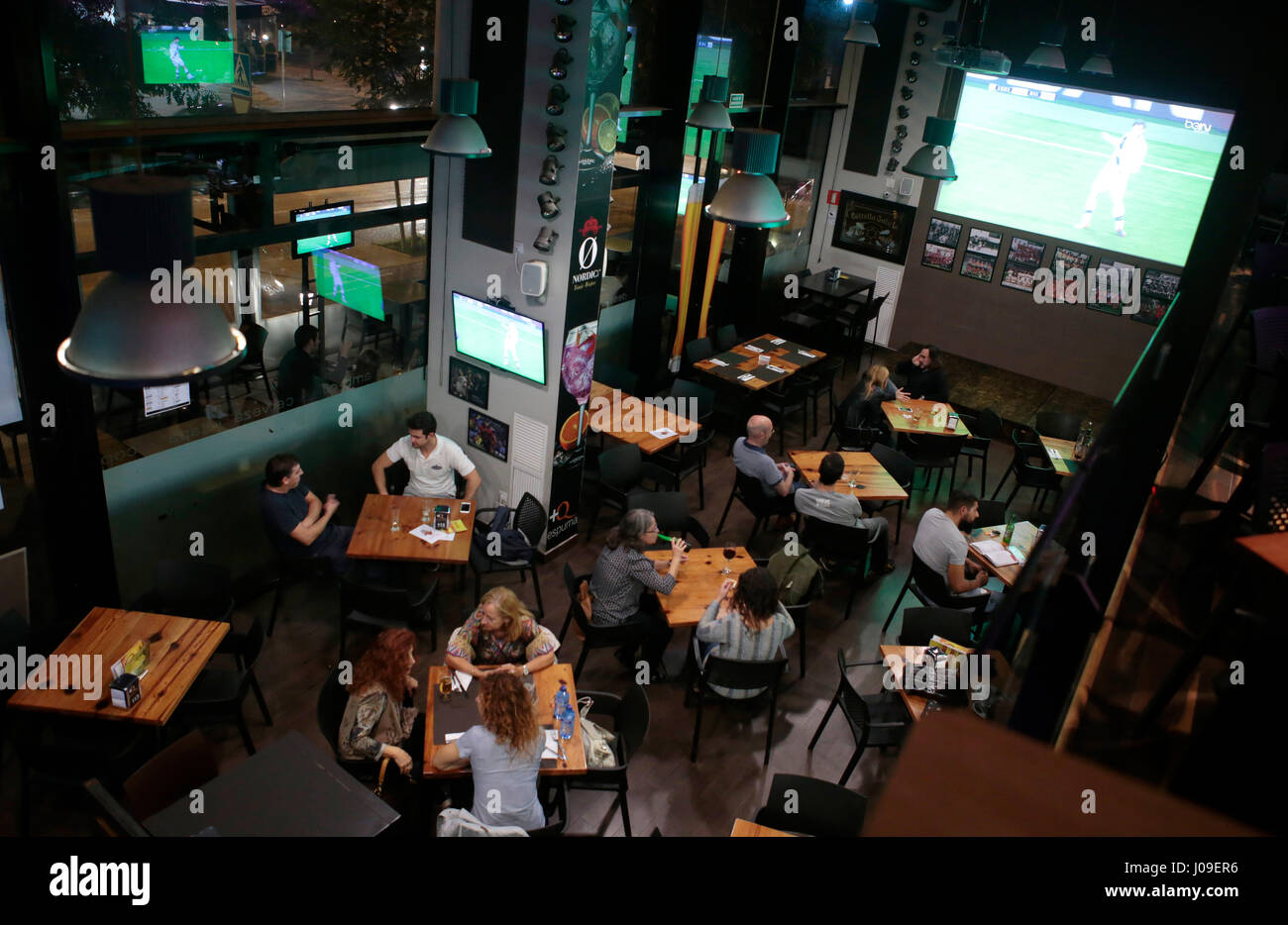bar with giant screens and sports broadcast Stock Photo