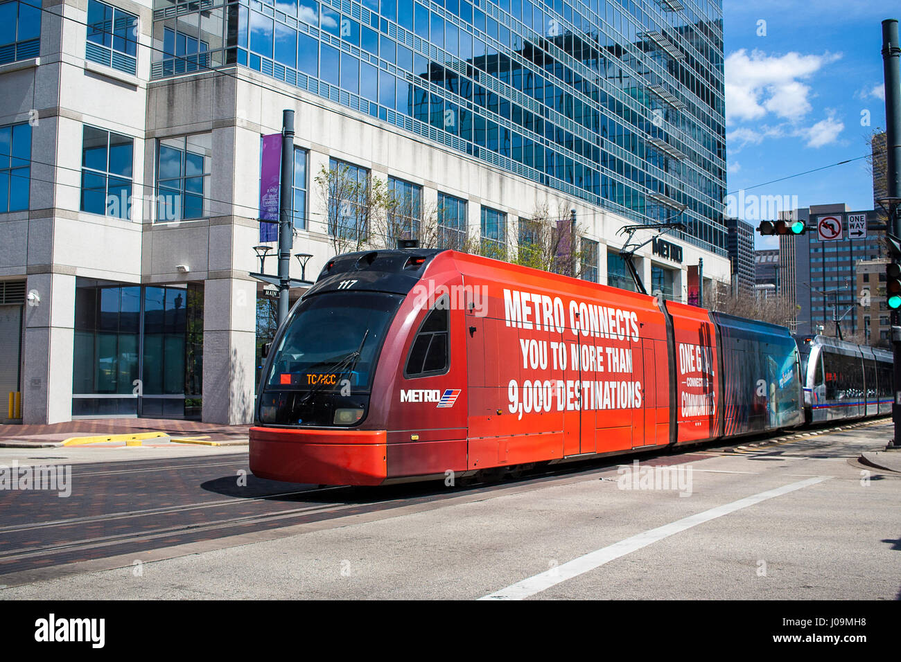 April 2017, Houston, Texas The metro light rail heading north through the traffic light towards