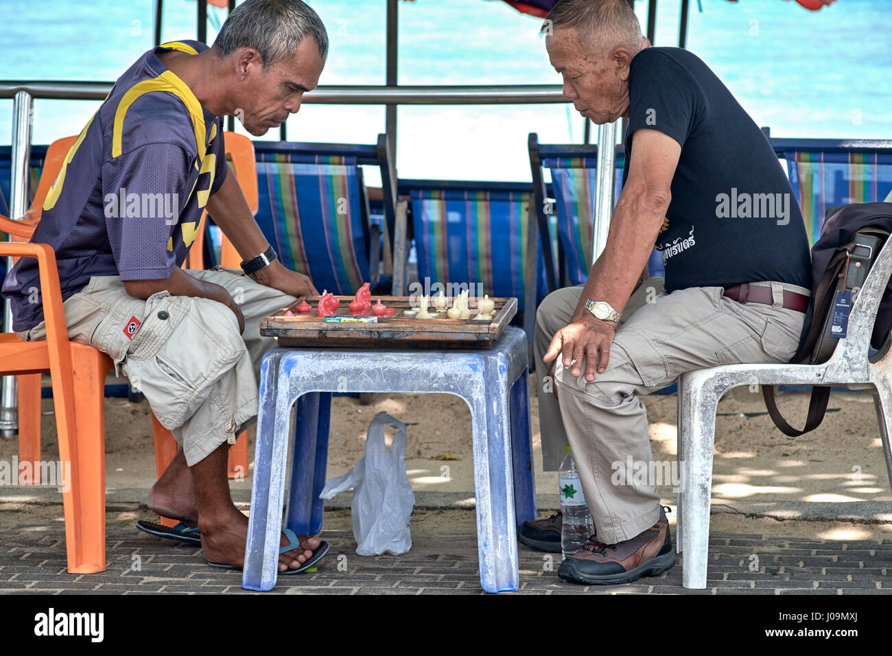 Men playing Makruk, which is a Thailand version of chess. Southeast Asia Stock Photo