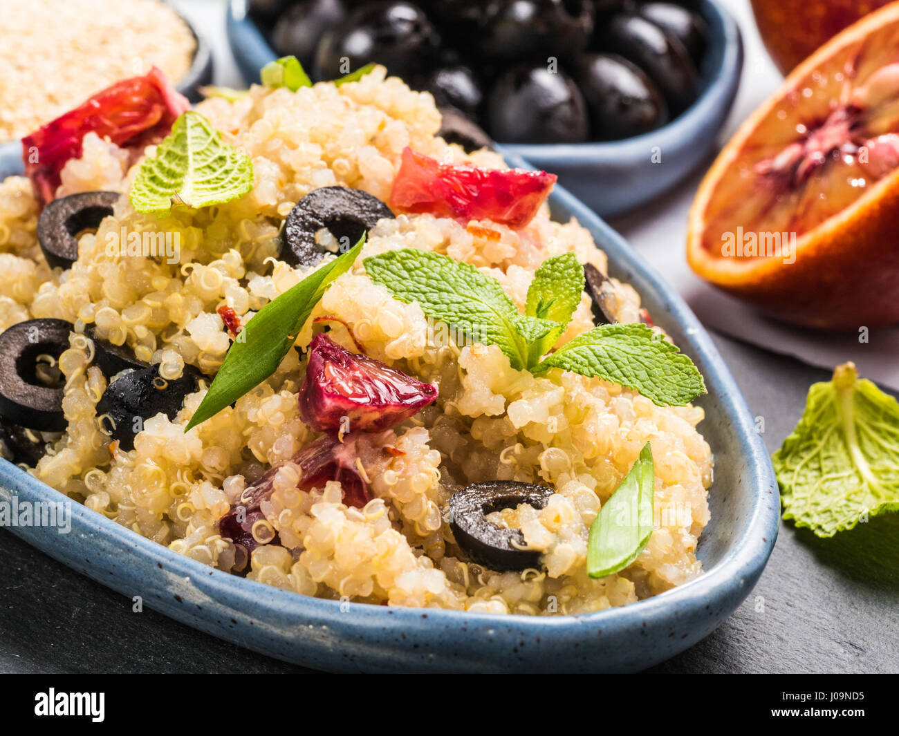 Vegan salad with quinoa, red orange and black olives Stock Photo