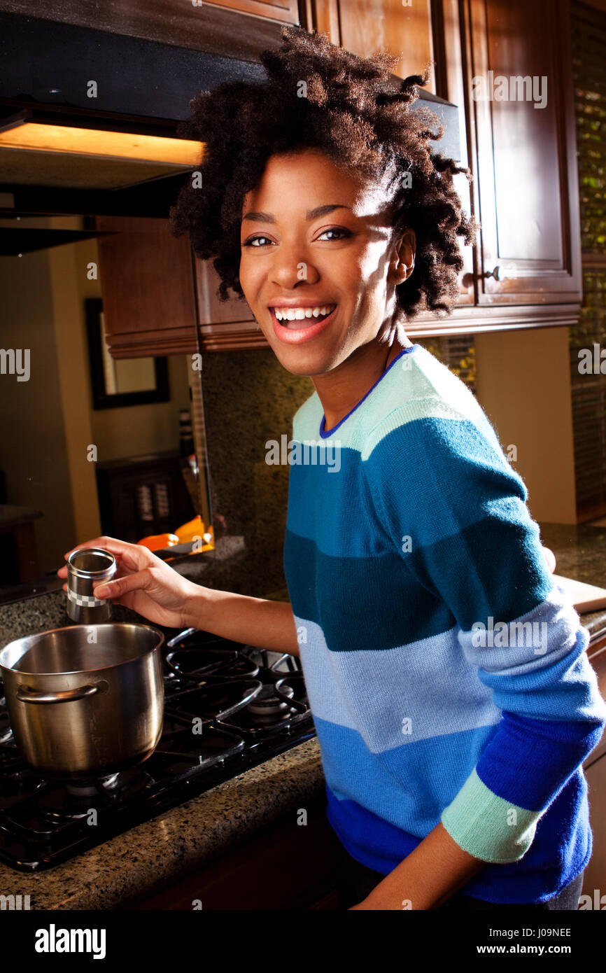 African American woman cooking in the kitchen Stock Photo - Alamy
