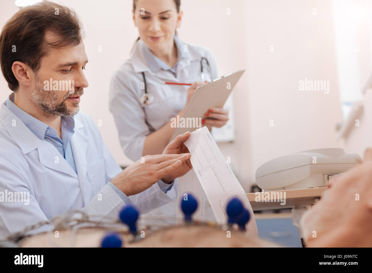 Great professional nurse helping a doctor Stock Photo