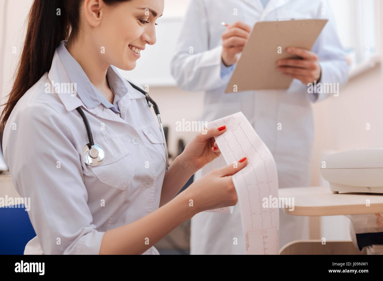 Delighted professional cardiologist telling about positive tendencies Stock Photo