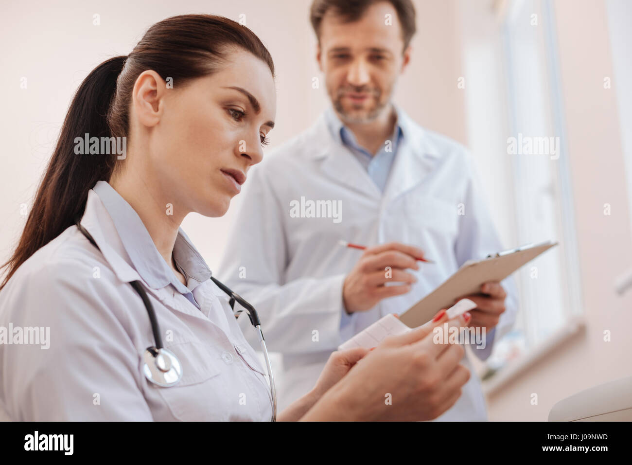 Competent capable cardiologist looking focused Stock Photo