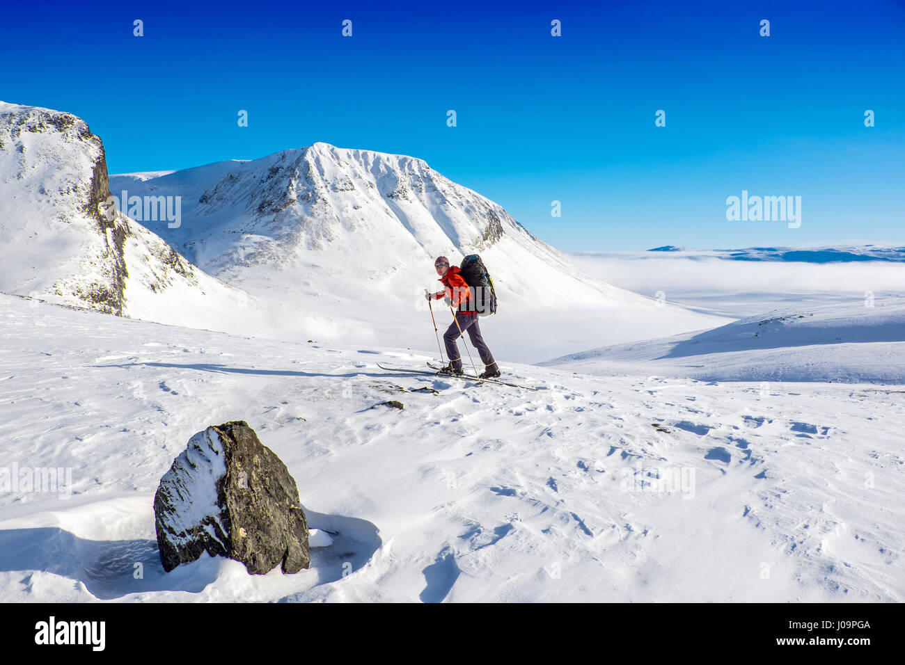 Ski-tourers skiing the Troms Border Trail, a long distance route in mountains of Northern Norway and Sweden Stock Photo