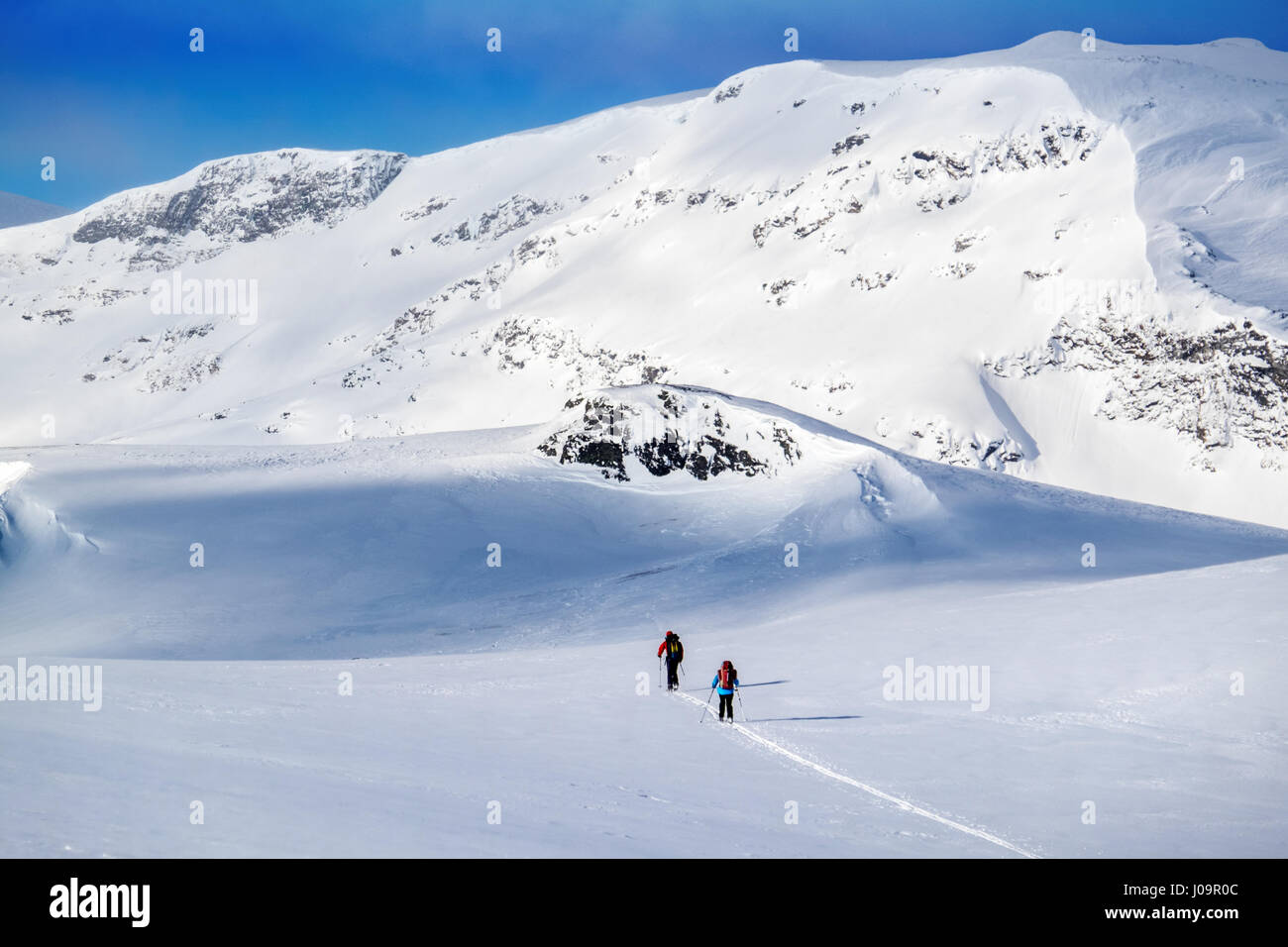 Ski-tourers skiing the Troms Border Trail, a long distance route in mountains of Northern Norway and Sweden Stock Photo