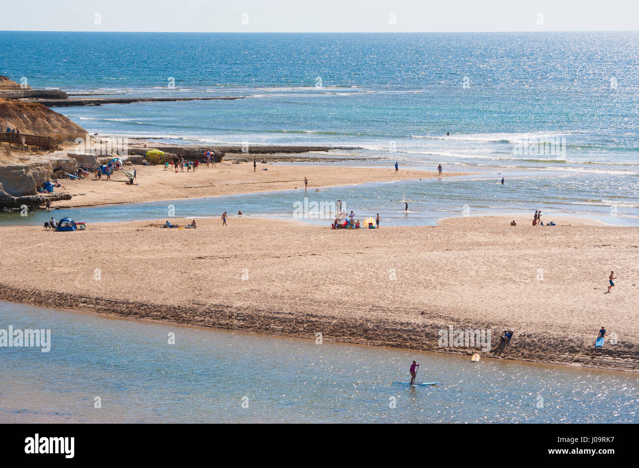 Summer fun on Southport Beach, where suburbs Port Noarlunga and Port Noarlunga South meet, divided by the Onkaparinga river estuary in South Australia Stock Photo