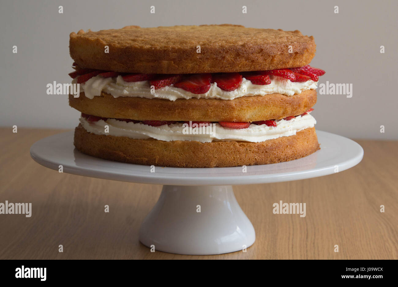 Victoria Sponge Cake with Whipped Cream and Strawberry Stock Photo