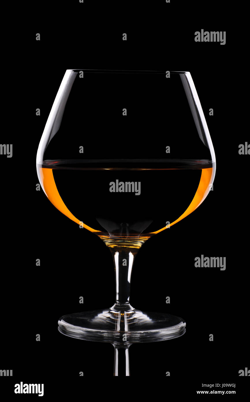Snifter glass with beautiful amber coloured alcohol Stock Photo Alamy