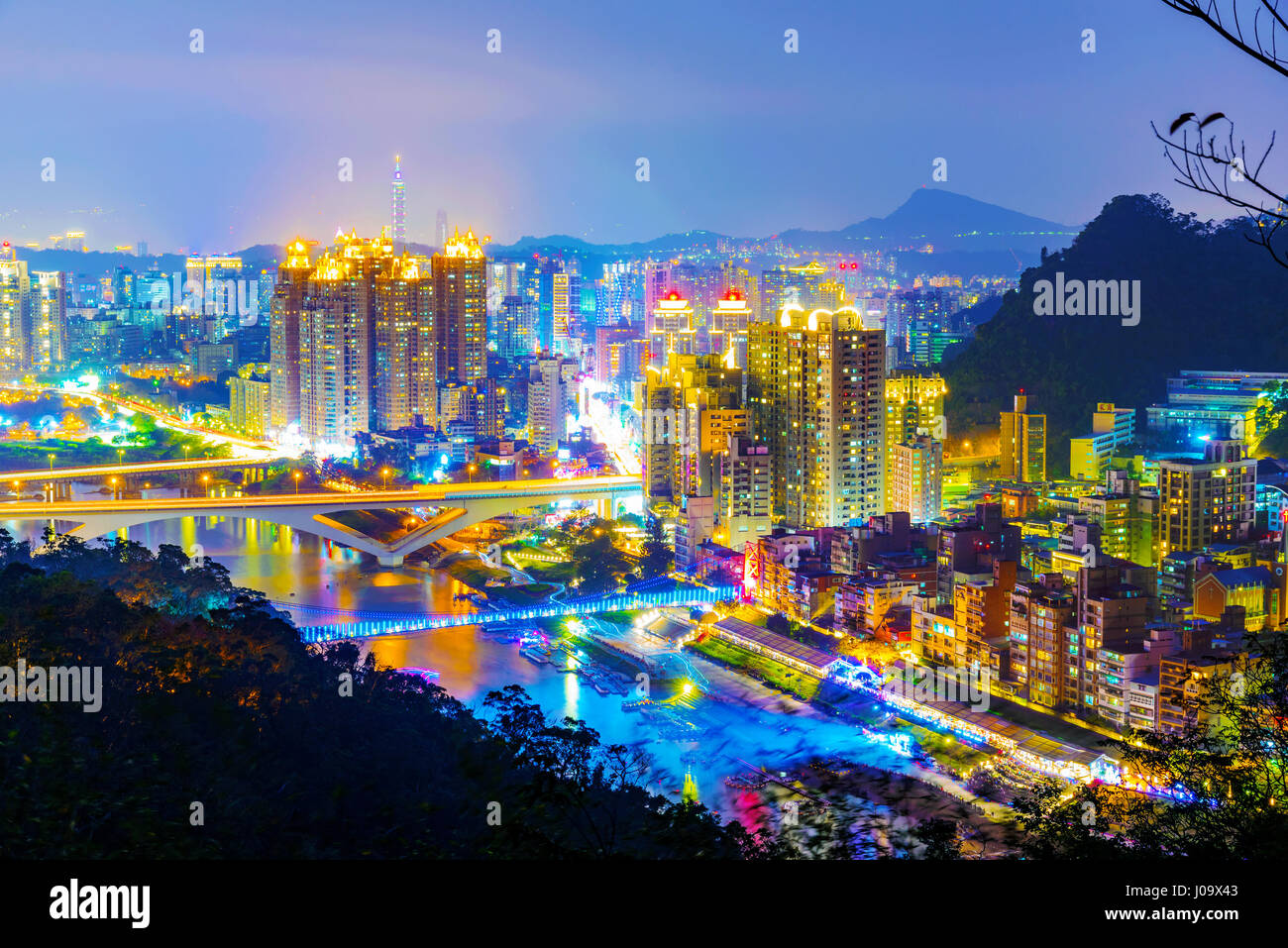 View of New Taipei city buildings at night from a mountain in Xindian Stock Photo
