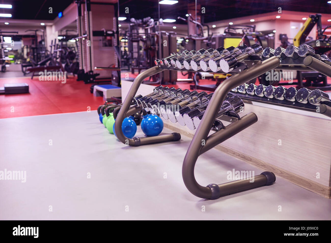 Sports dumbbells weights  in the gym interior Stock Photo