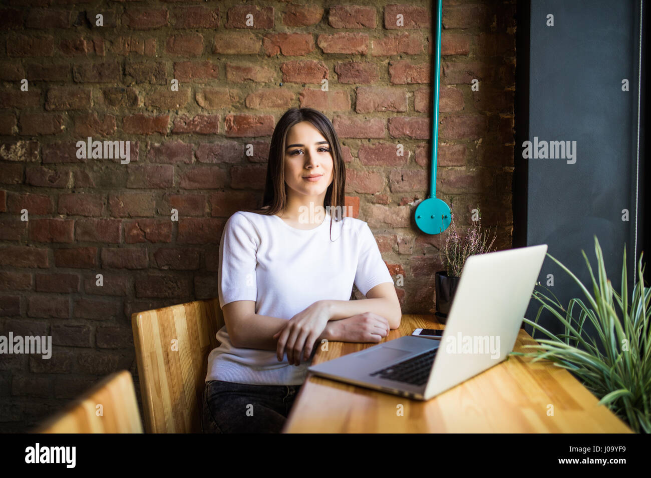 Side view of a young businesswoman using laptop in cafe Stock Photo