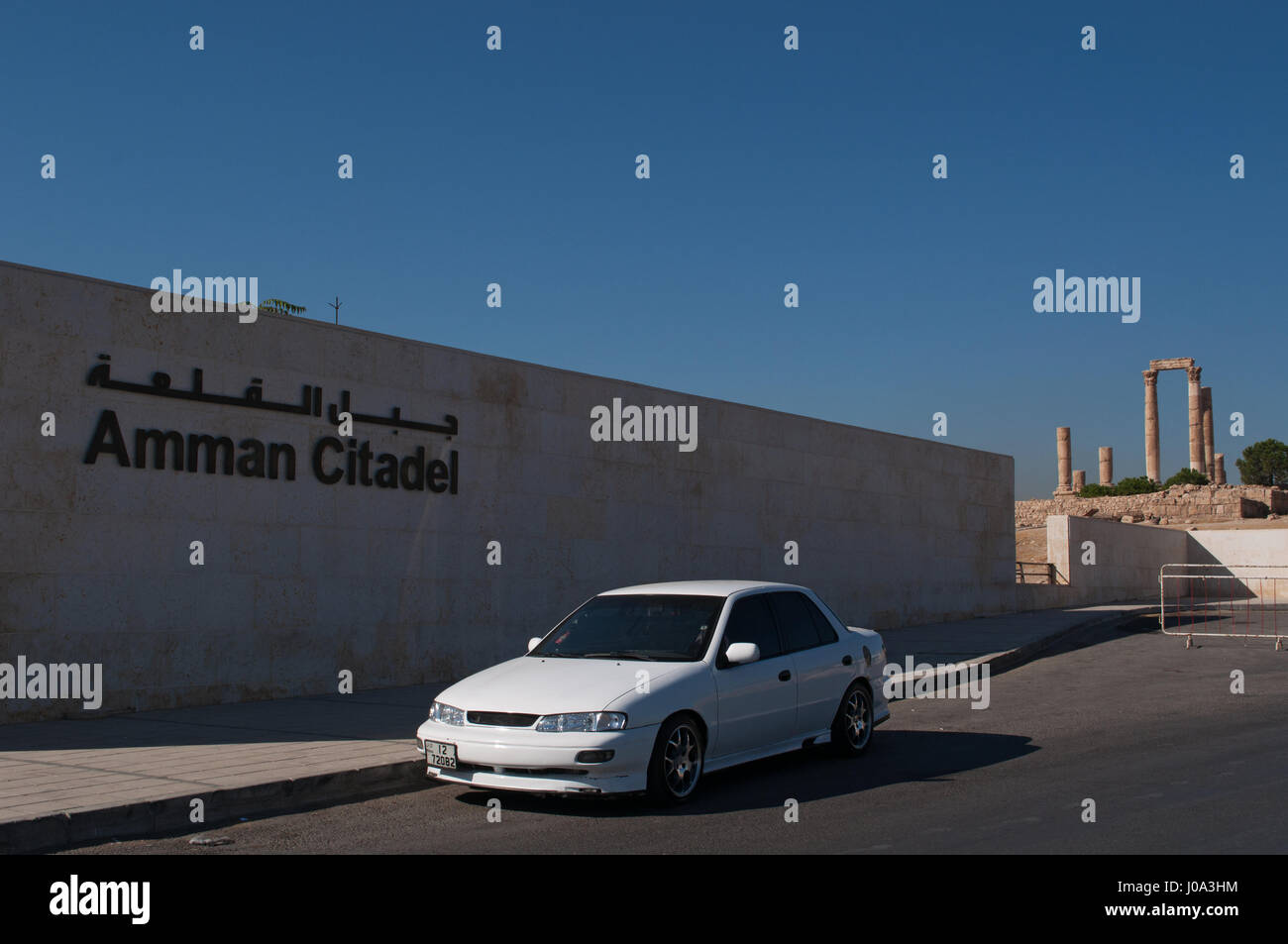 A car in front of the access to the Amman Citadel, the archaeological site and one of the original nucleus of the town, with the Temple of Hercules Stock Photo