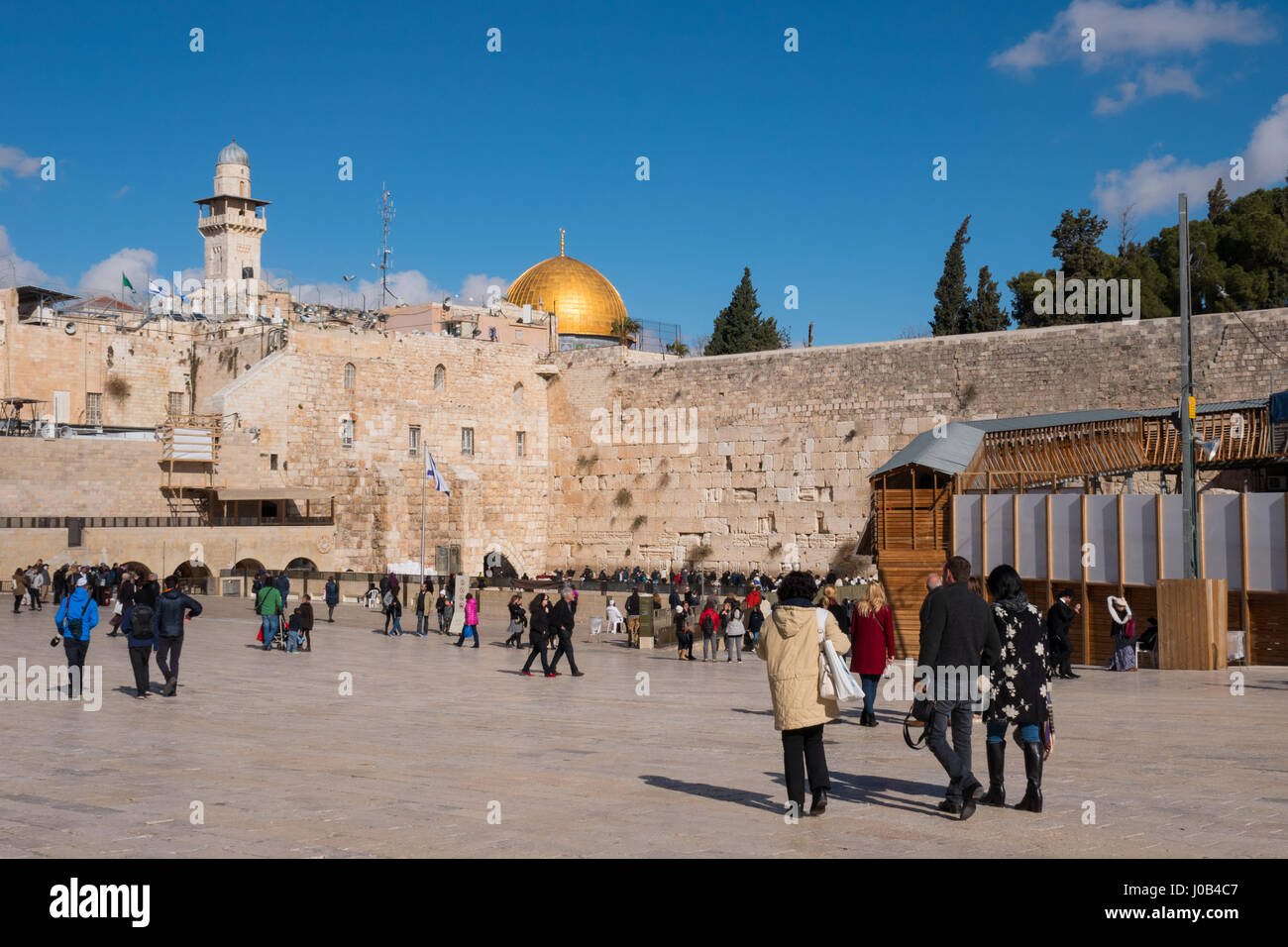 People pray at the western wall. The western wall is an exposed section of ancient wall situated on the western flank of the Temple Mount. Stock Photo