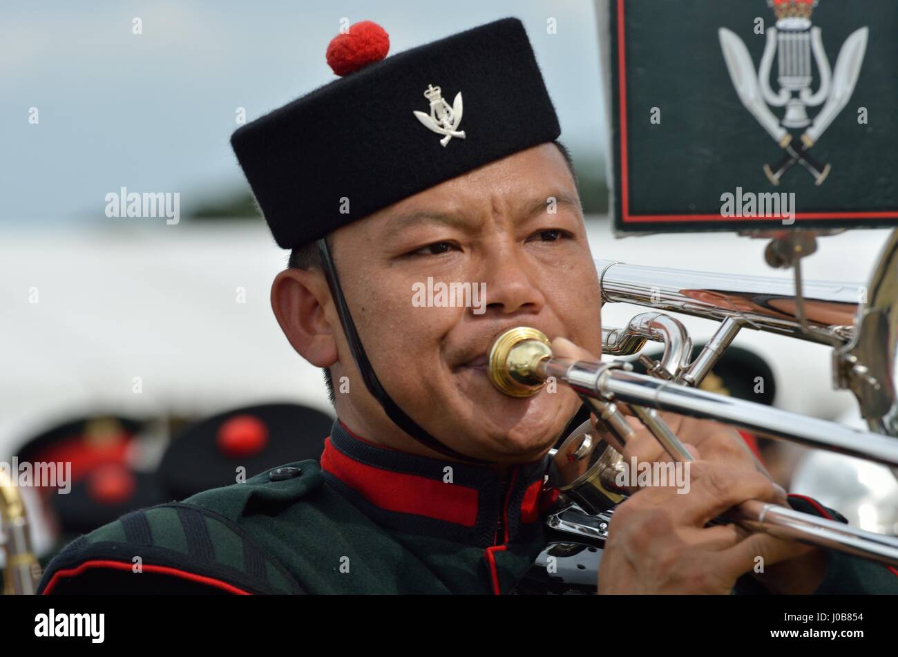 Military Tattoo  COLCHESTER ESSEX UK 8 July 2014:   Gurkha soldier blowing trumpet Stock Photo