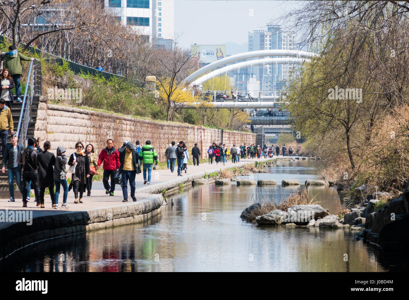 Locals and tourists enjoy a walk at Cheonggye Stream near Dongdaemun Market. A modern public recreation space in downtown Seoul, South Korea. Stock Photo