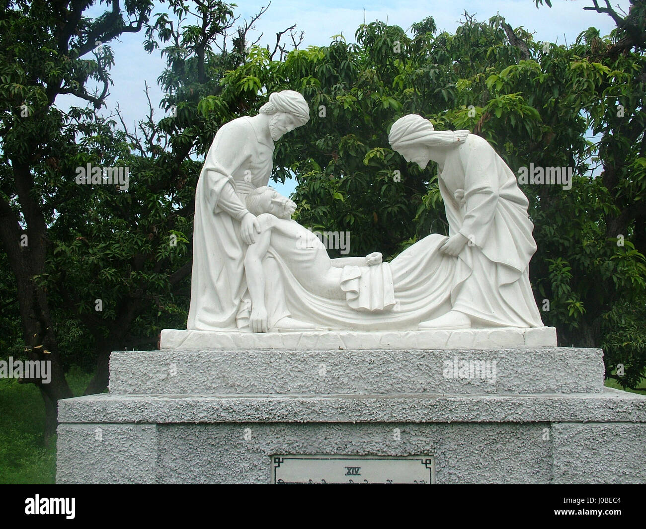 Statue: Fourteenth Station, Jesus is laid in the tomb. Basilica of Our Lady of Graces, Begum's Church, Sardhana (Copyright © by Saji Maramon) Stock Photo