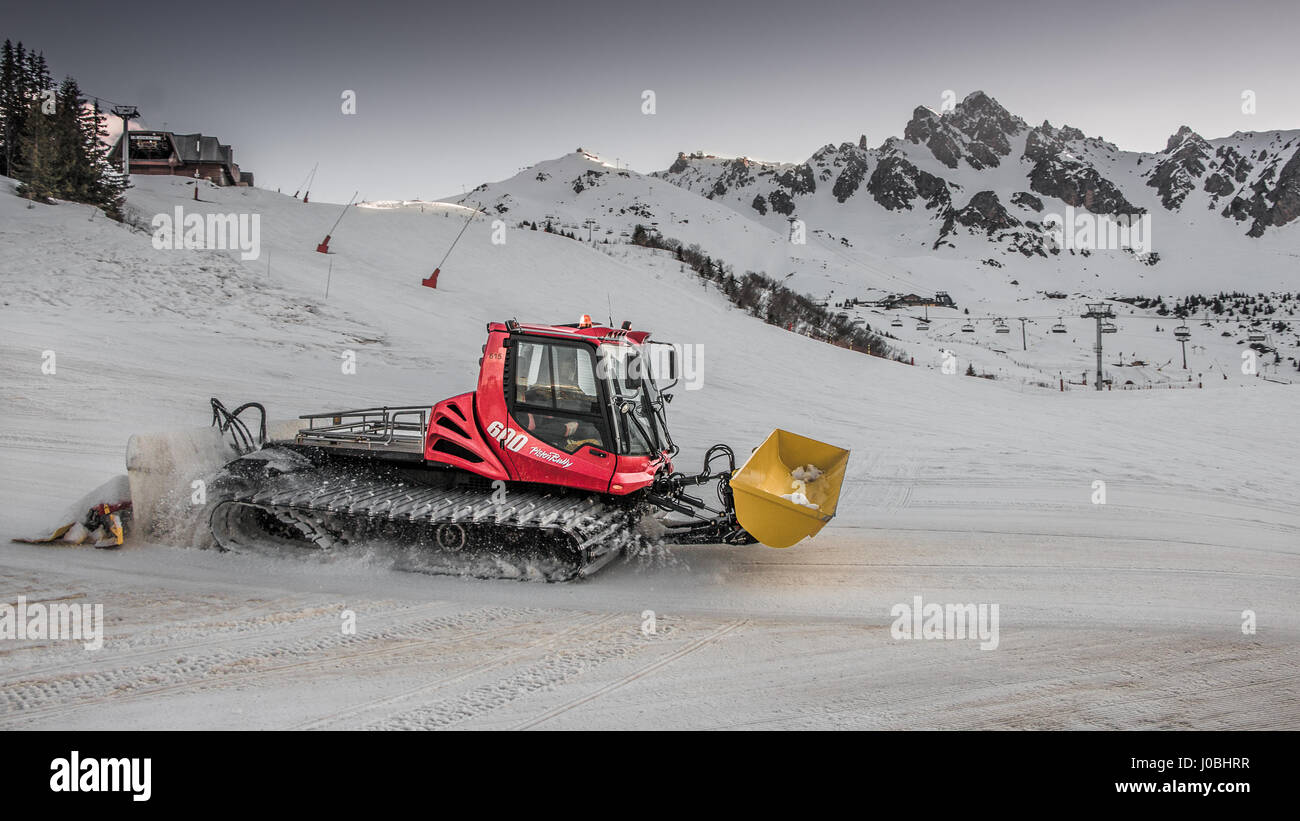 Piste Basher at Work in the Ski Resort of Courchevel in the 3 Valleys Les Trois Vallées of France Stock Photo