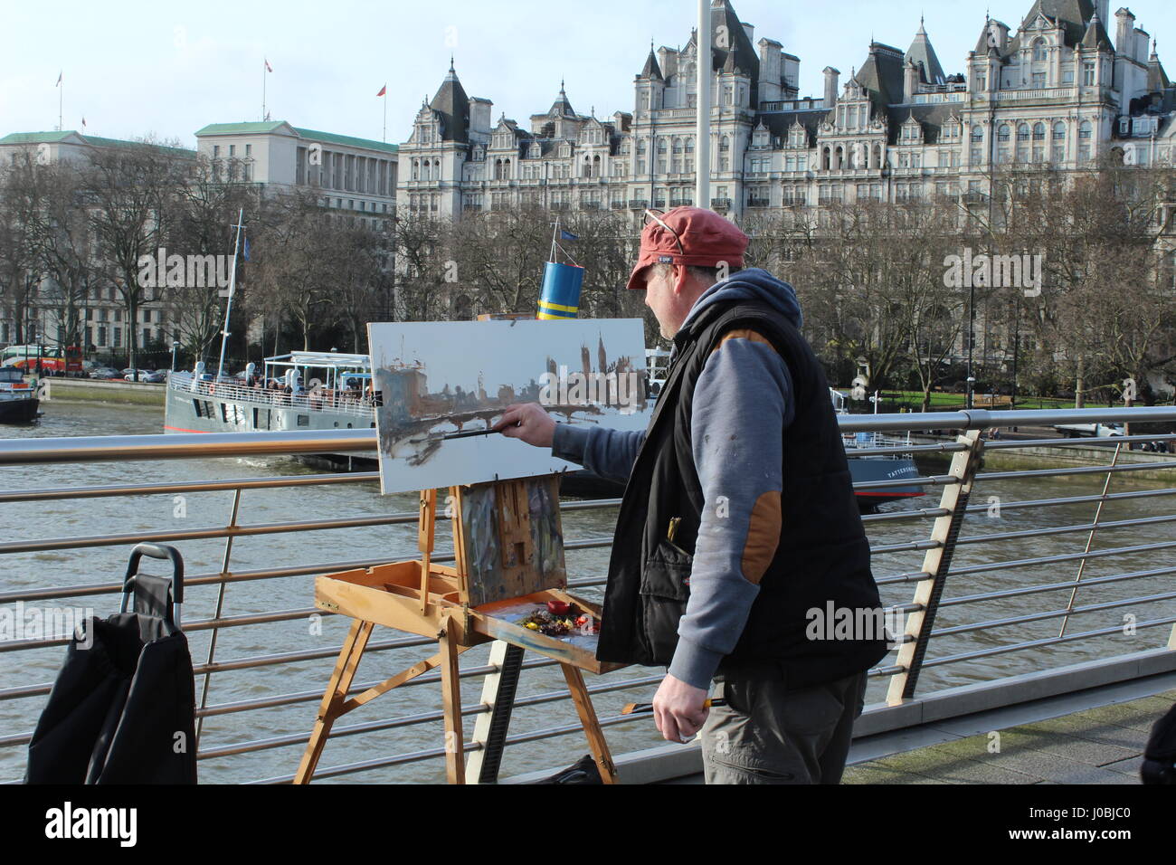 london street artist painting on a london bridge Stock Photo