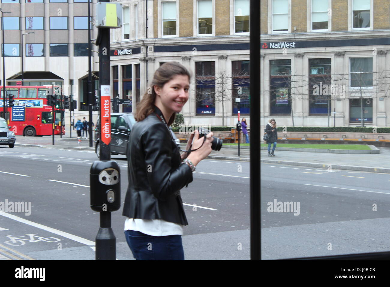 young women with camera in London street taking photos Stock Photo