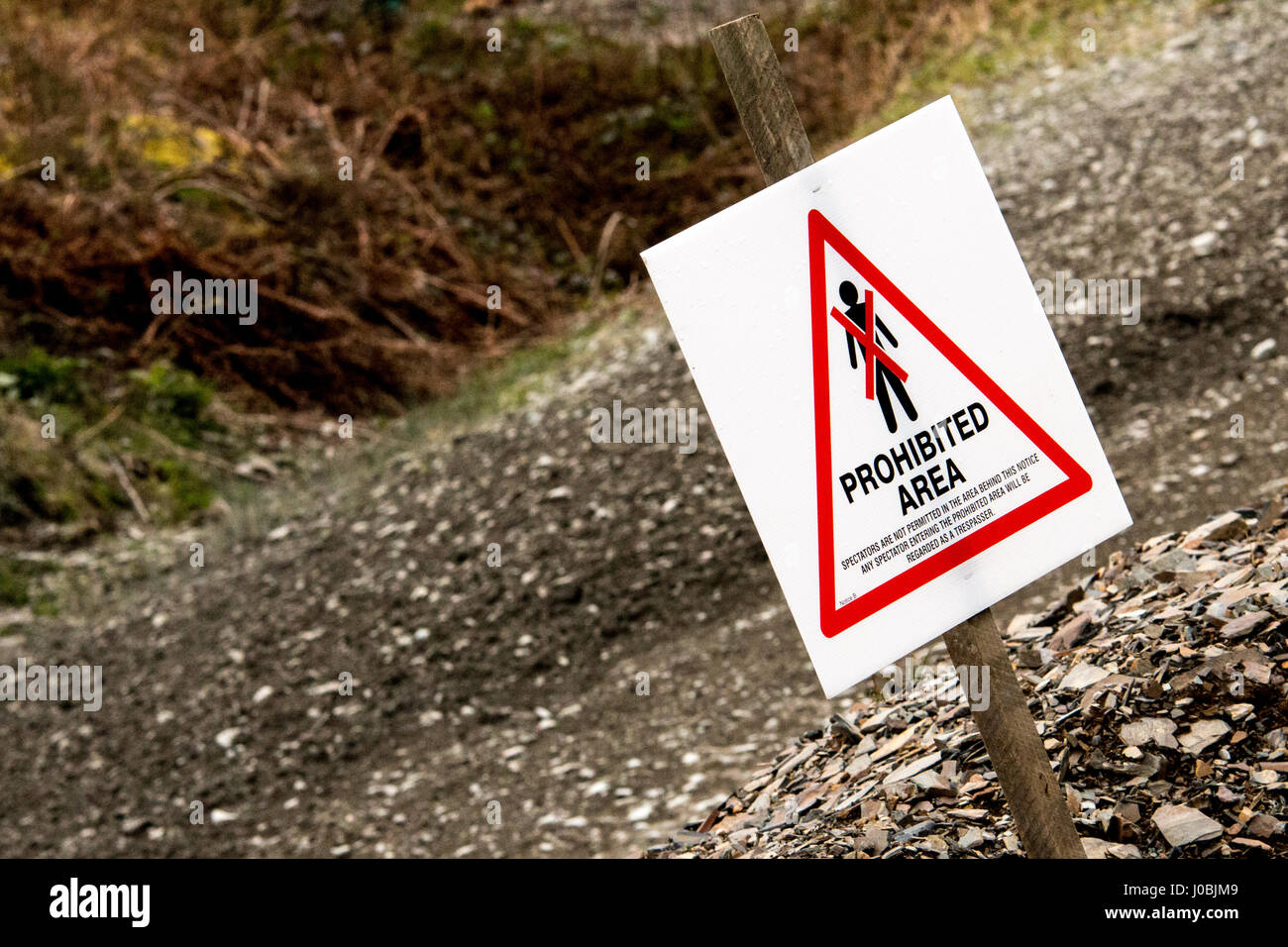 A view of a spectator safety sign on a British Motorsport forest rally event, indicating an area unsafe for spectators. Stock Photo