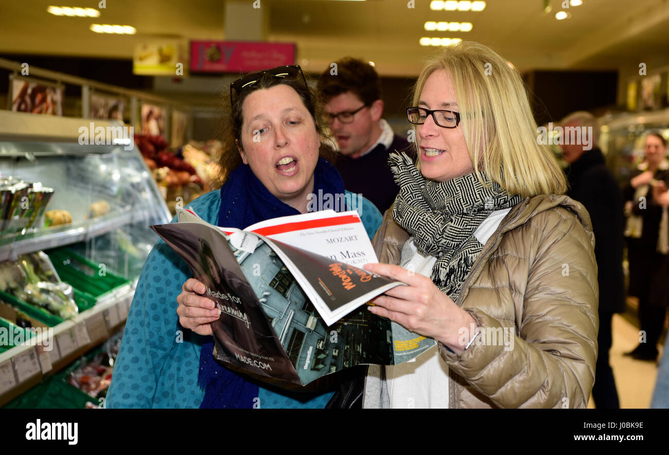 Female shoppers in Waitrose supermarket, Alton, Hampshire, UK, 25.03.2017, part of a flash mob singing opera. Stock Photo