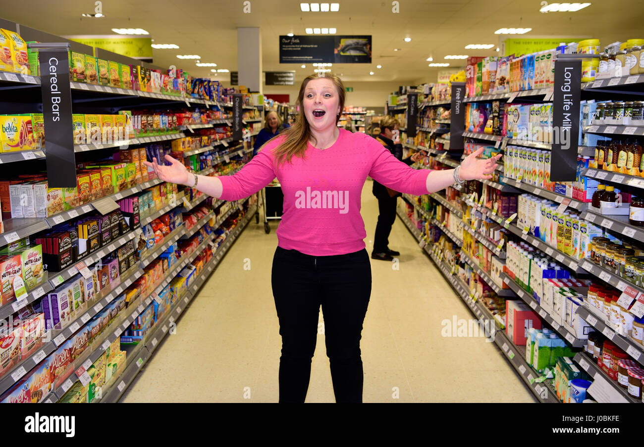 Female, part of a flash mob, singing opera in Waitrose supermarket, Alton, Hampshire, UK. 25.03.2017. Stock Photo