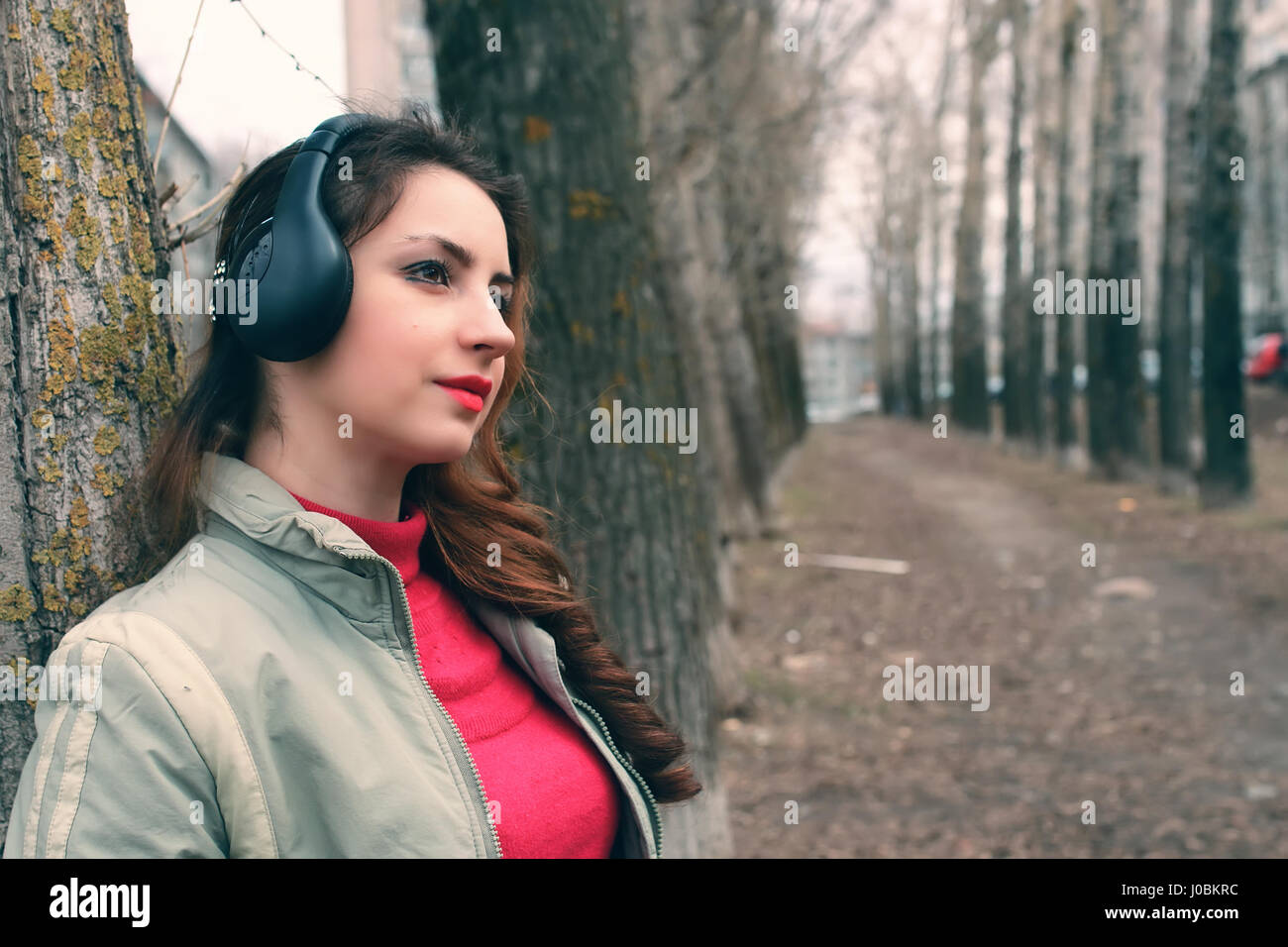 girl in park with headphone Stock Photo