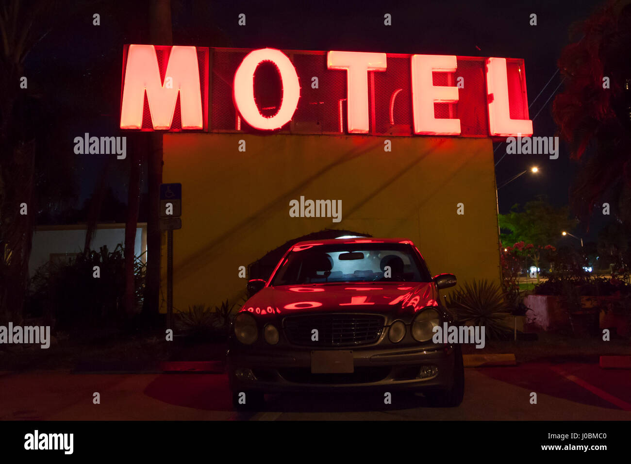 Red motel sign illuminated at night. Florida, United States Stock Photo
