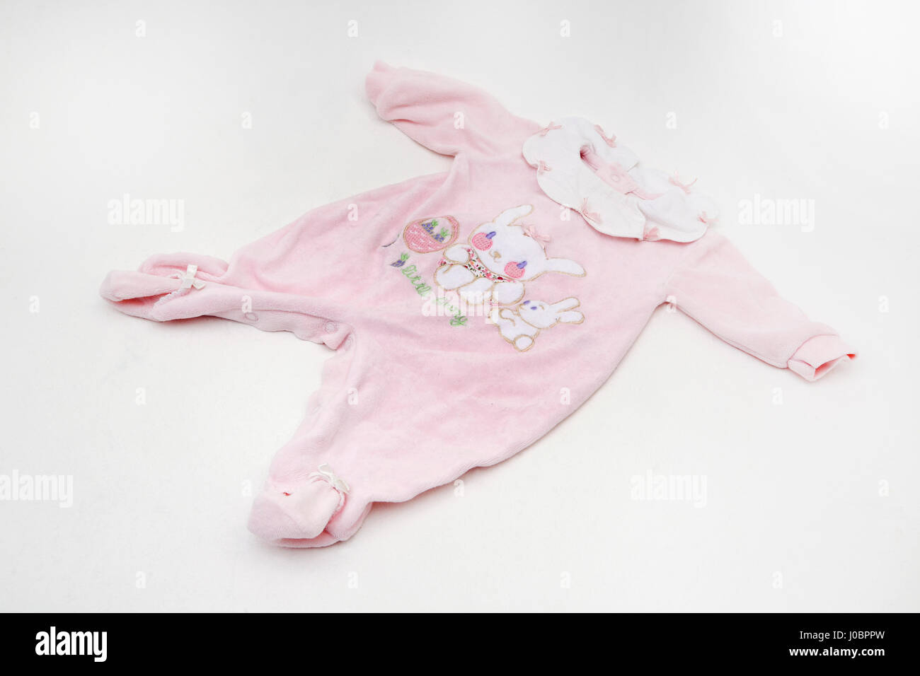 Pink All In One Baby Grow With collar and a Rabbit design Stock Photo