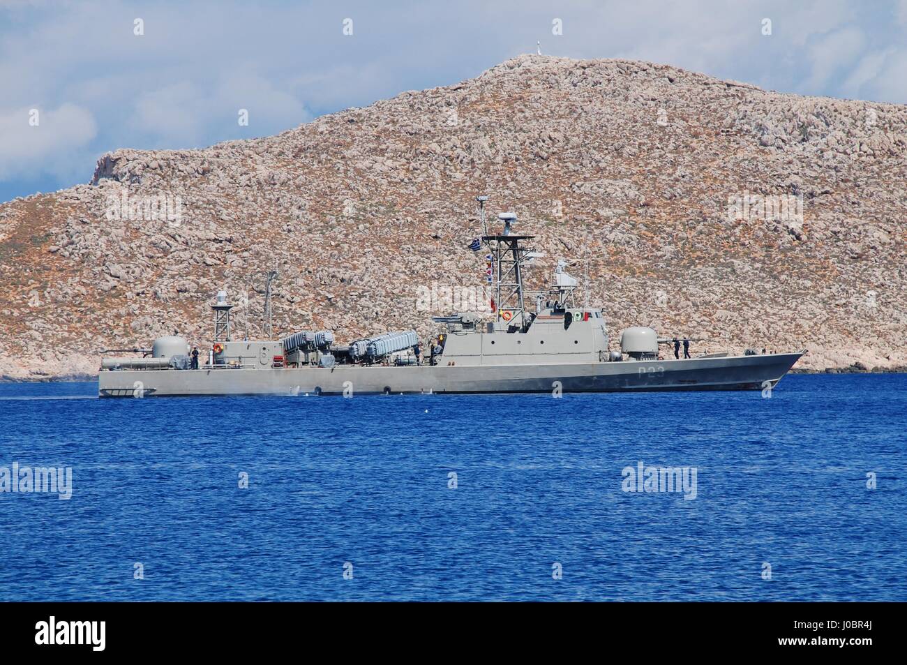 Hellenic navy patrol boat Antipliarchos Mykonios departs Emborio harbour on the Greek island of Halki. The French built vessel entered service in 1978 Stock Photo