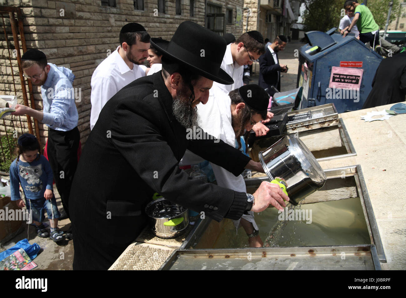 Orthodox Jews need to immerse culinary utensils in a container with mikveh or well water if they were made by Gentiles or bought from them before use. Stock Photo