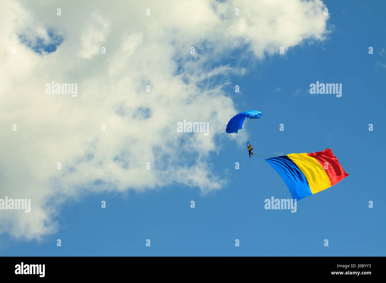 CLUJ-NAPOCA, CLUJ/ROMANIA - MAY 18: Parachutist from the Romanian Aeroclub Team jumps with the biggest Romanian flag to date on the Romanian Air Fest  Stock Photo