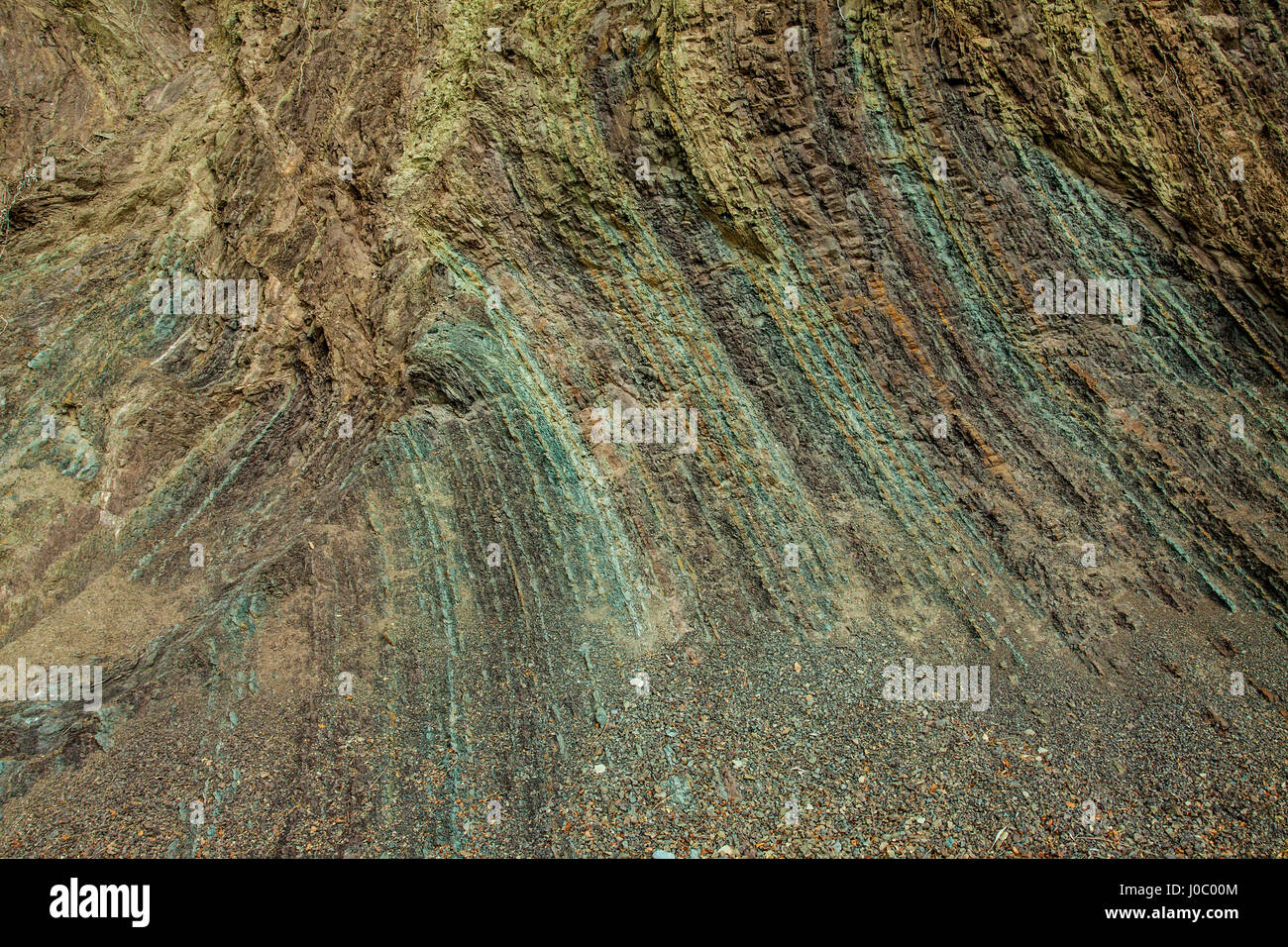 Layered rock texture of a cliff shore with many colors for individual layers Stock Photo