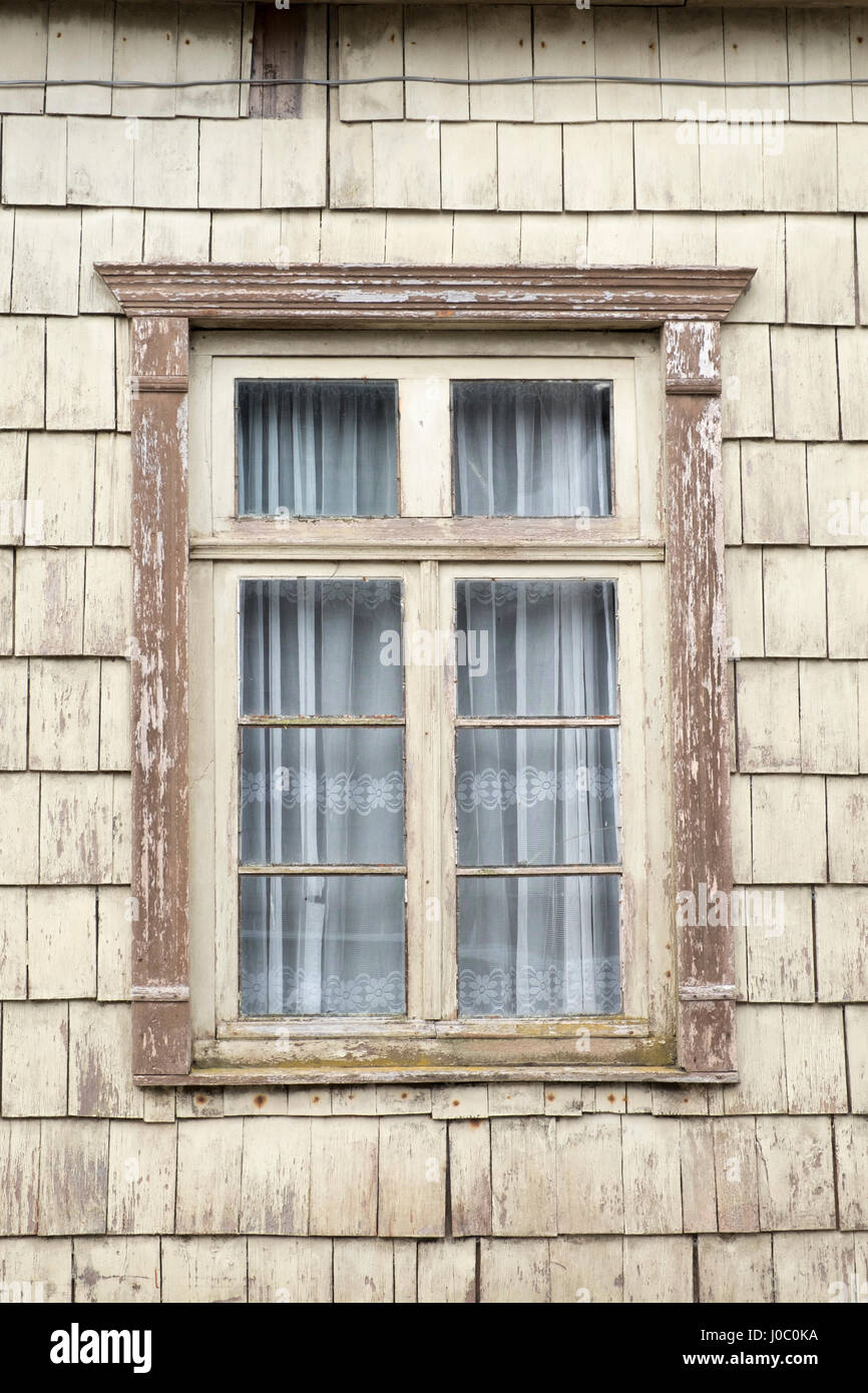 Distinctive wooden tiles around a window in Chiloe Island, Northern Patagonia, Chile Stock Photo