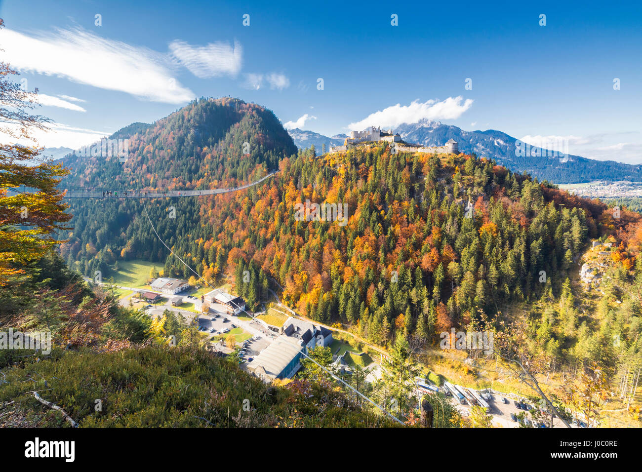 View of the old Ehrenberg Castle surrounded by colorful woods and suspension bridge, Highline 179, Reutte, Austria Stock Photo