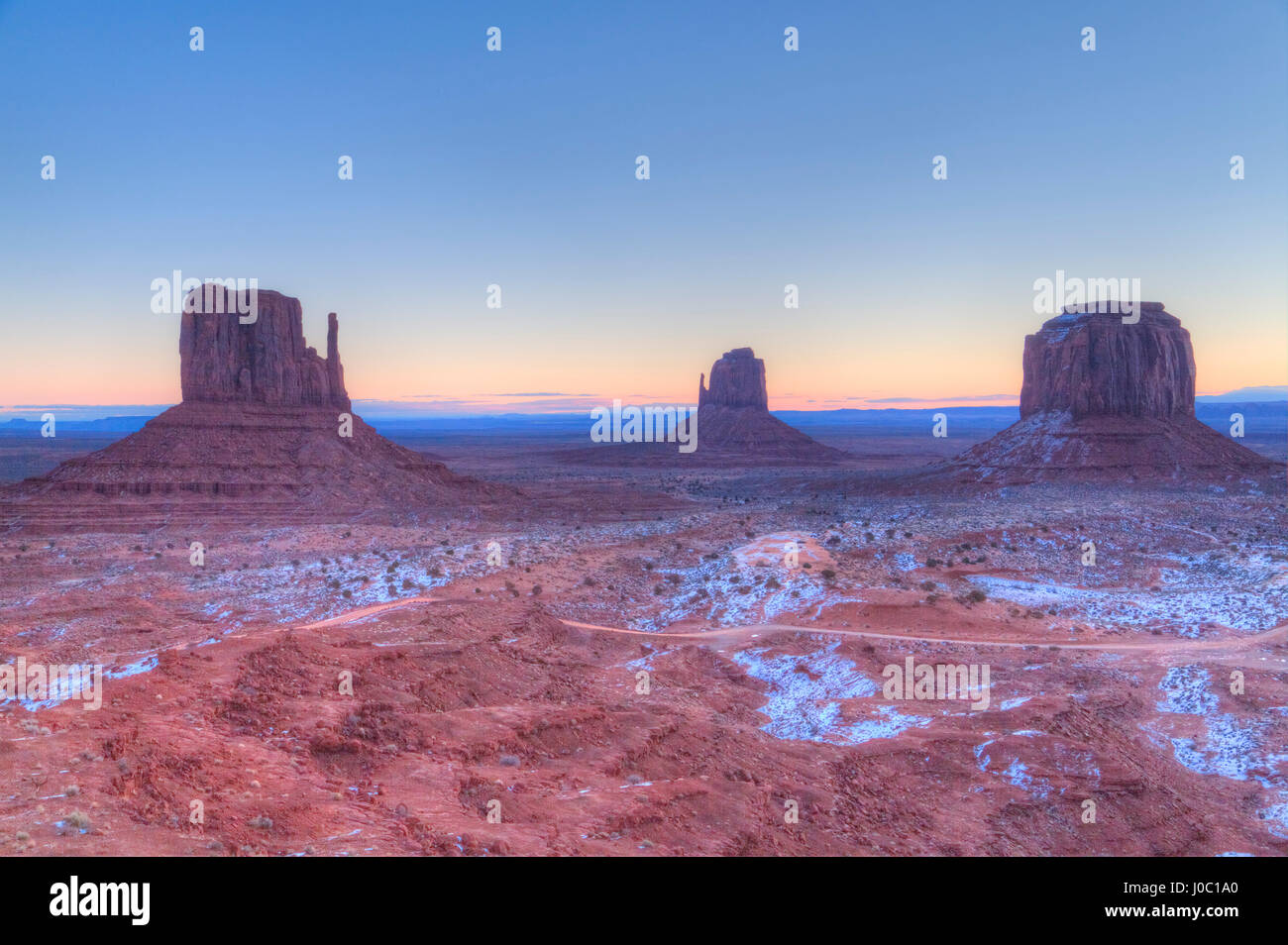 Sunrise, West Mitten Butte, Mitten Butte in centre, and Merrick Butte on right, Monument Valley Navajo Tribal Park, Utah, USA Stock Photo