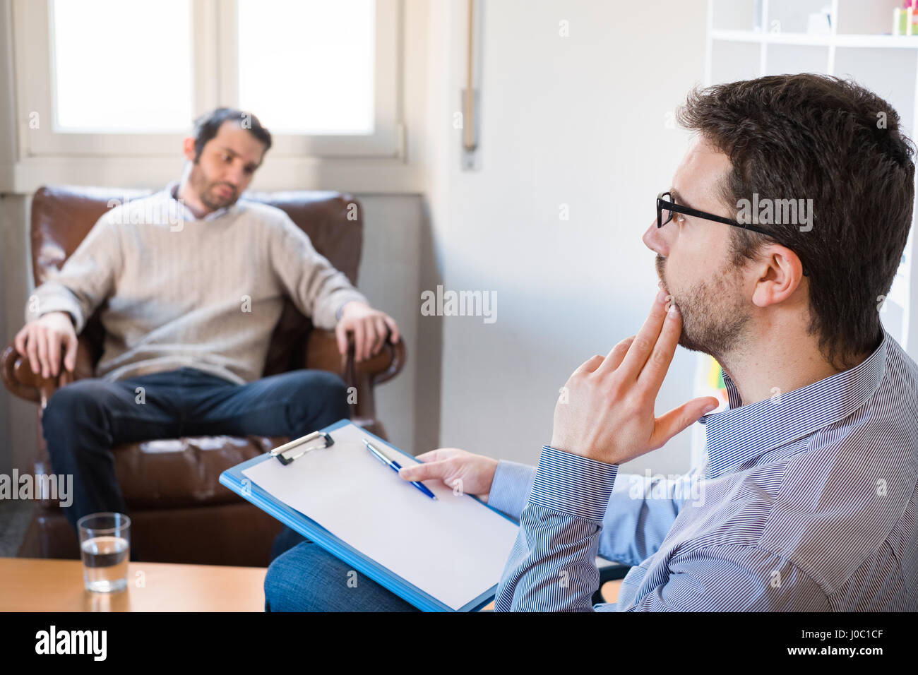 Psychologist taking notes during psychotherapy session Stock Photo Alamy