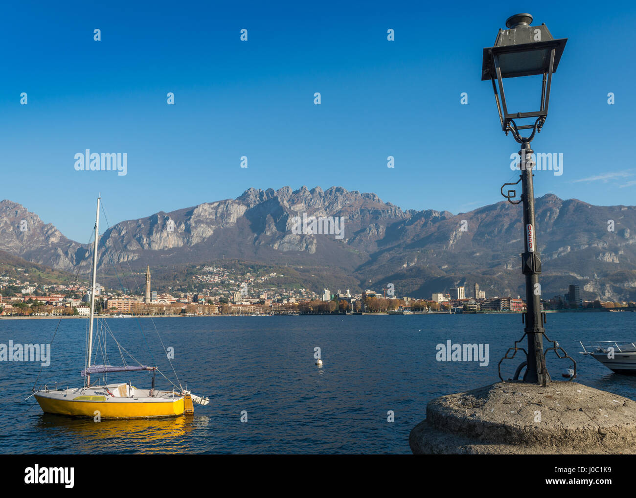 Lake of Lecco, a branch of Lake Como in the southern Alps with the city of Lecco in the background, Lombardy, Italy Stock Photo