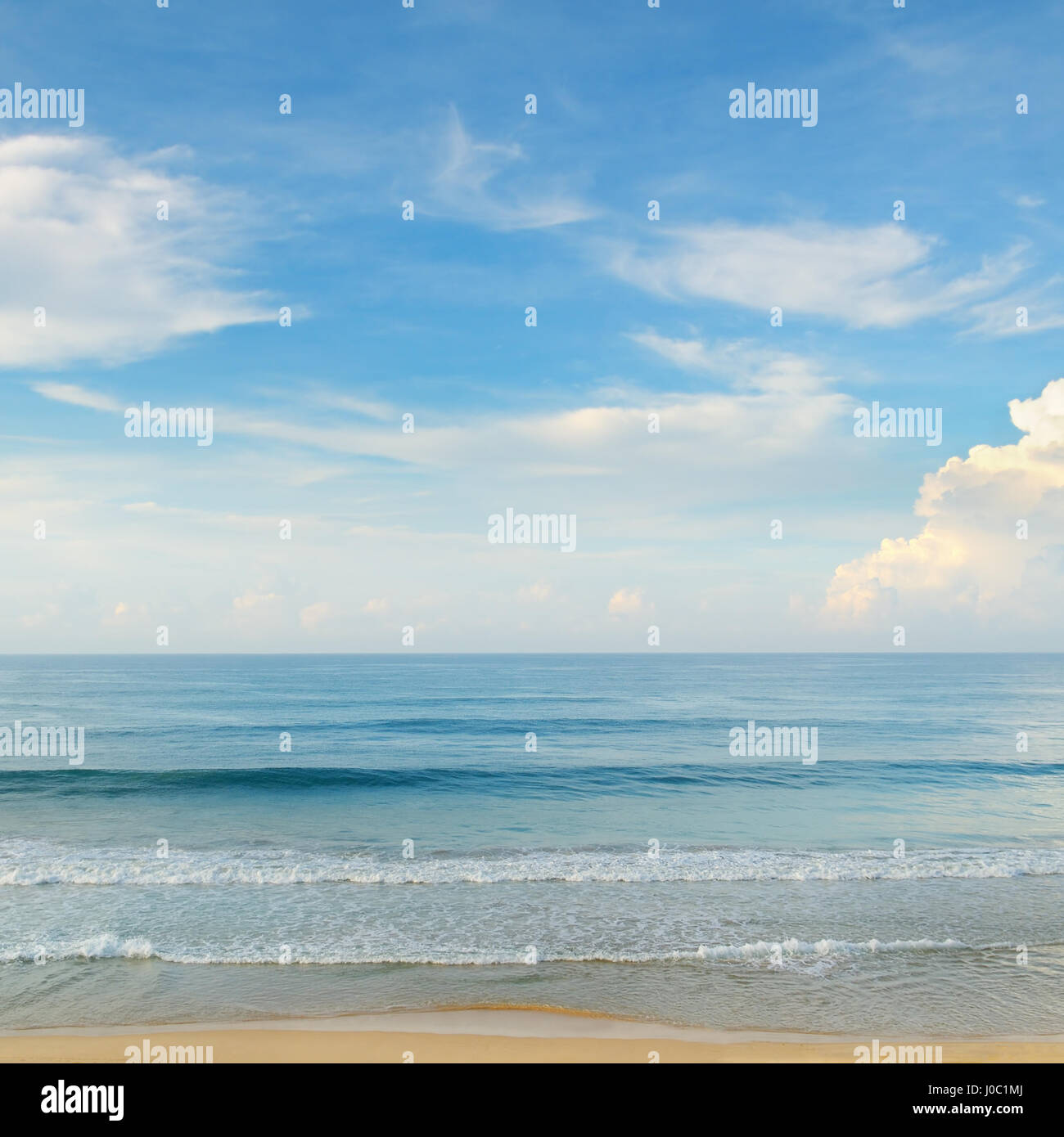 ocean, sandy beach and blue sky Stock Photo - Alamy