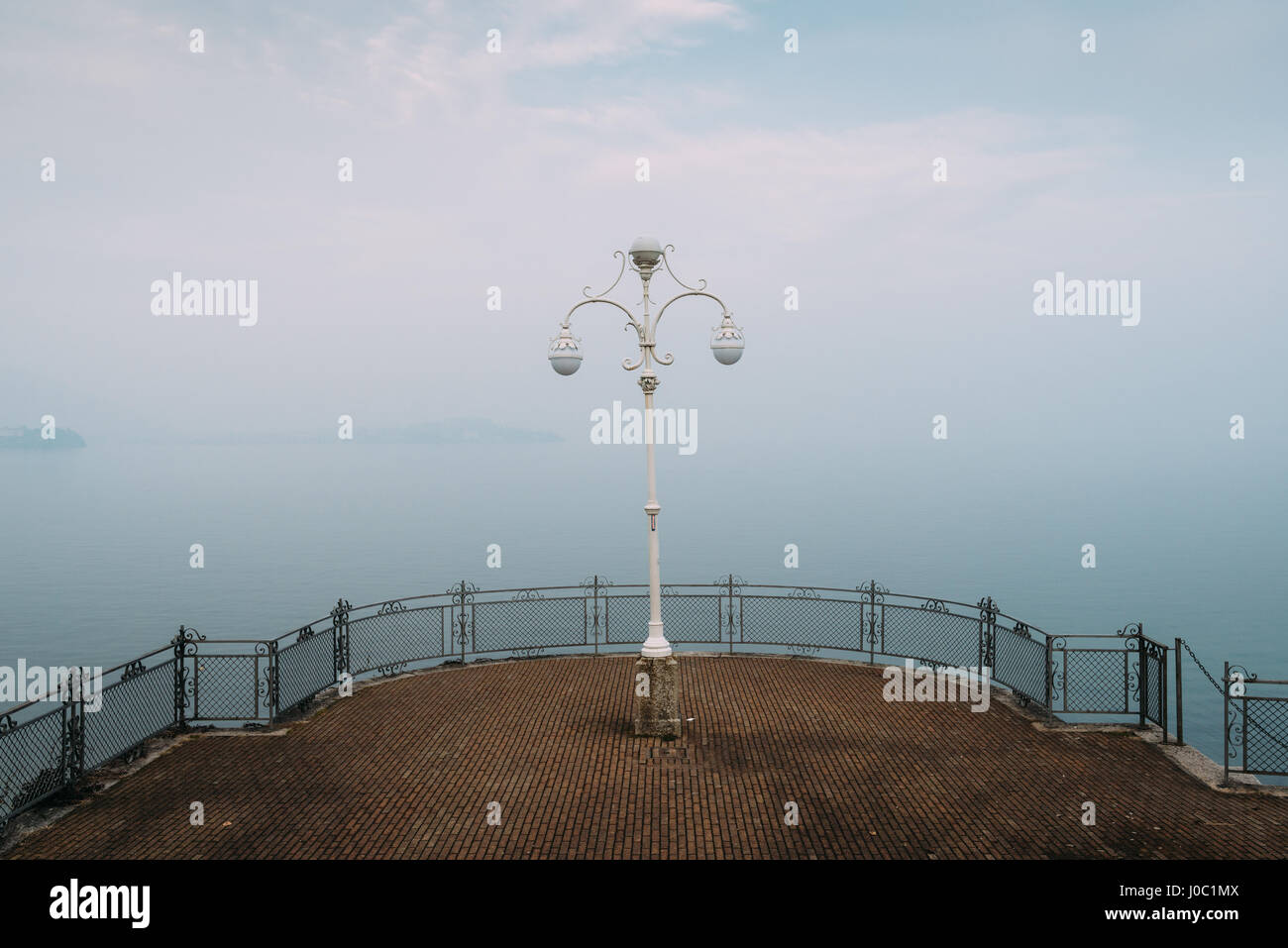 A symmetrical spot with a lamp overlooking Lake Maggiore, Piedmont, Italian Lakes, Italy Stock Photo
