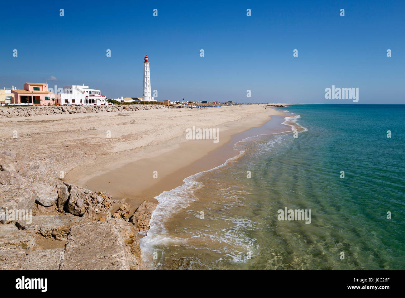 Lighthouse and beach of Ilha do Farol, Culatra barrier island, Olhao, Algarve, Portugal Stock Photo