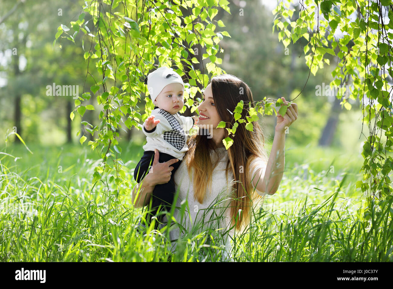 Mother with child under a birch Stock Photo