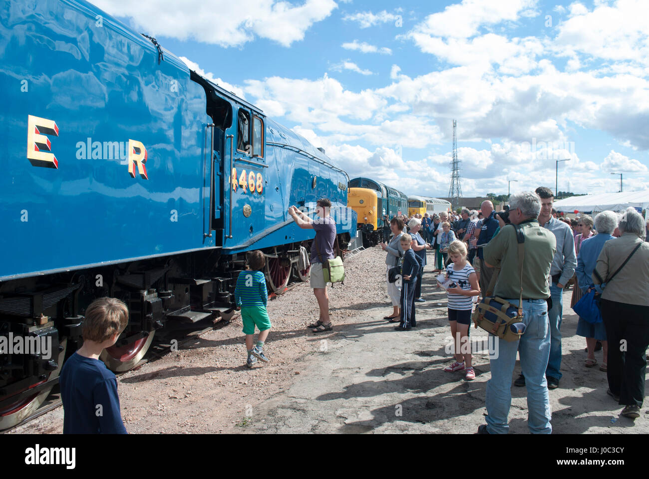 Man photographing side of Mallard steam train Stock Photo