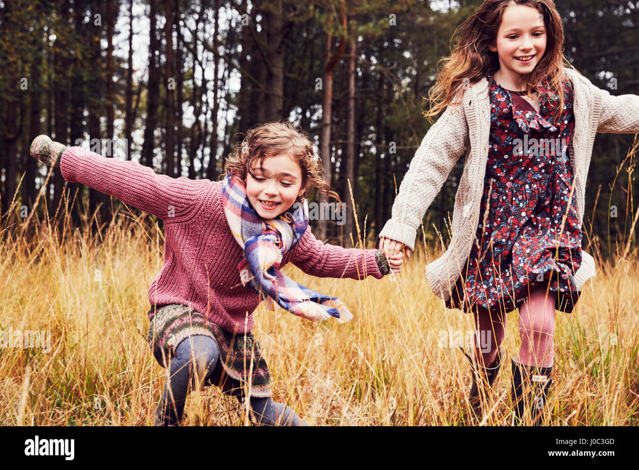 Two girls running holding hands hi-res stock photography and images - Alamy