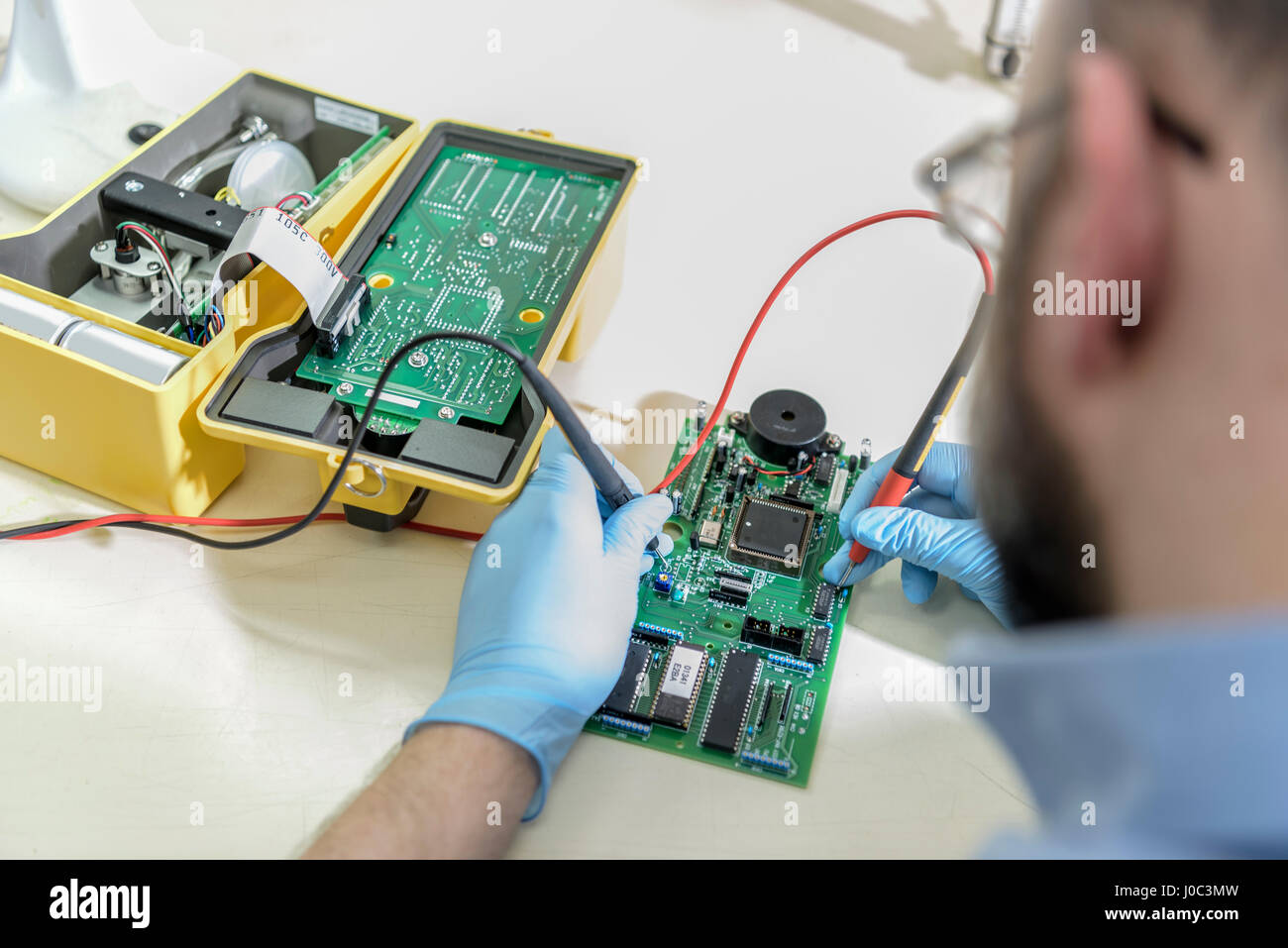 Worker testing electrical components in laboratory Stock Photo - Alamy