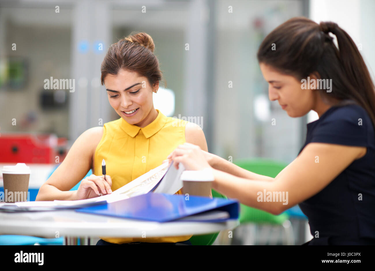 Business women with paperwork in meeting Stock Photo