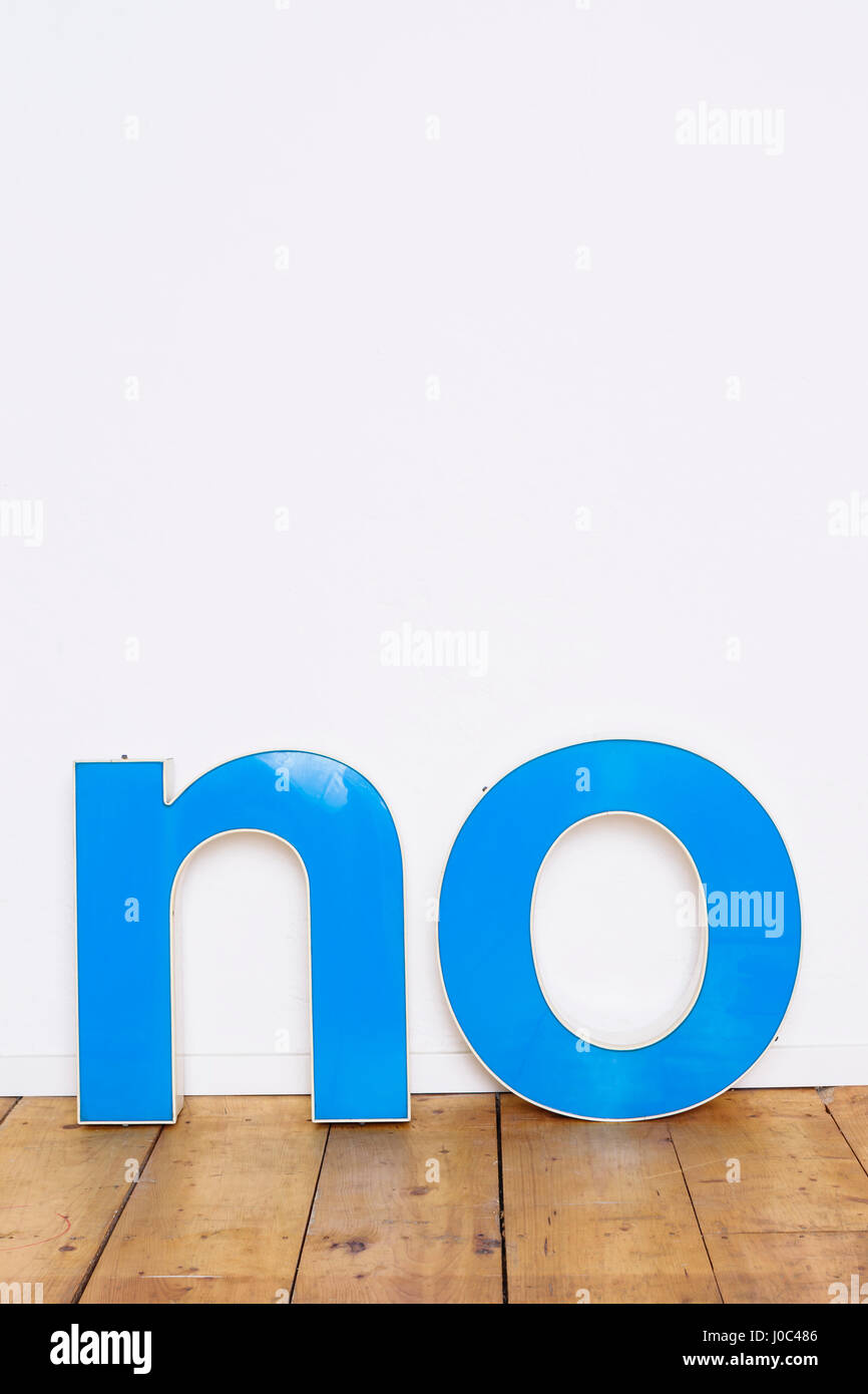 Large three-dimensional letters on wooden floor spelling the word NO Stock Photo